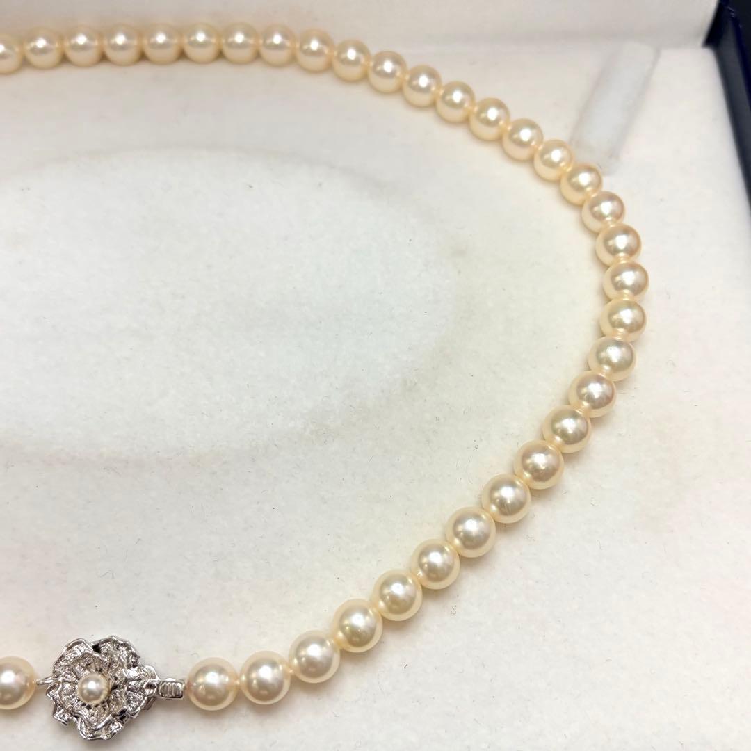 Akoya pearl necklace with 7.24mm white pearls and silver clasp on a white background