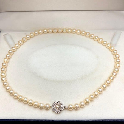 Akoya pearl necklace with 7.24mm white pearls and silver clasp on a white background