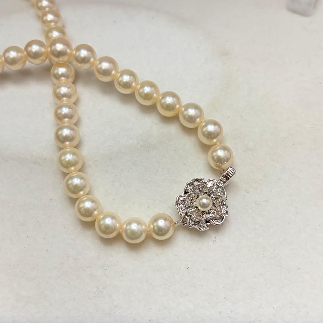 Akoya pearl necklace with 7.24mm white pearls and silver clasp on a white background