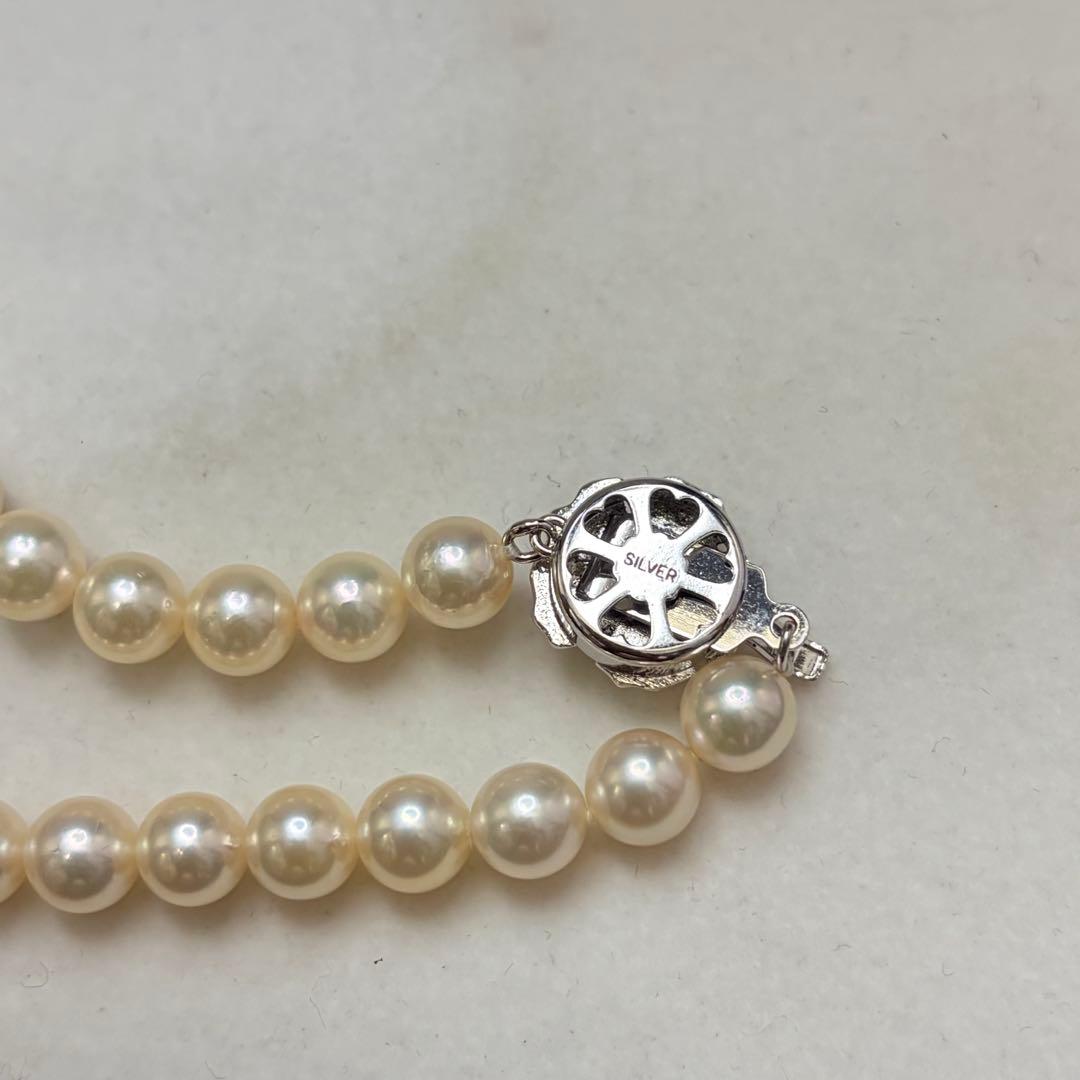 Akoya pearl necklace with 7.24mm white pearls and silver clasp on a white background