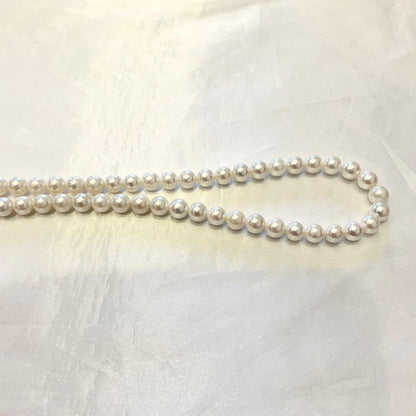 Akoya real pearl necklace with 7.0-7.5mm white pearls showing pink and green shades on a 44cm strand