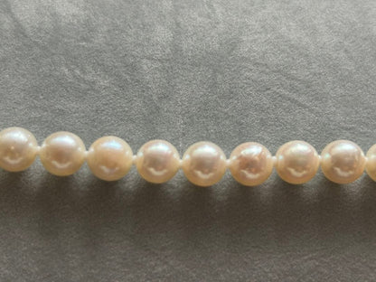 Akoya pearl necklace and matching earrings with silver clasp and certification sheet