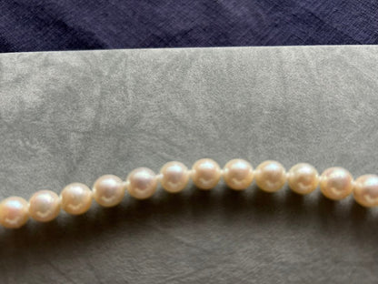 Akoya pearl necklace and matching earrings with silver clasp and certification sheet