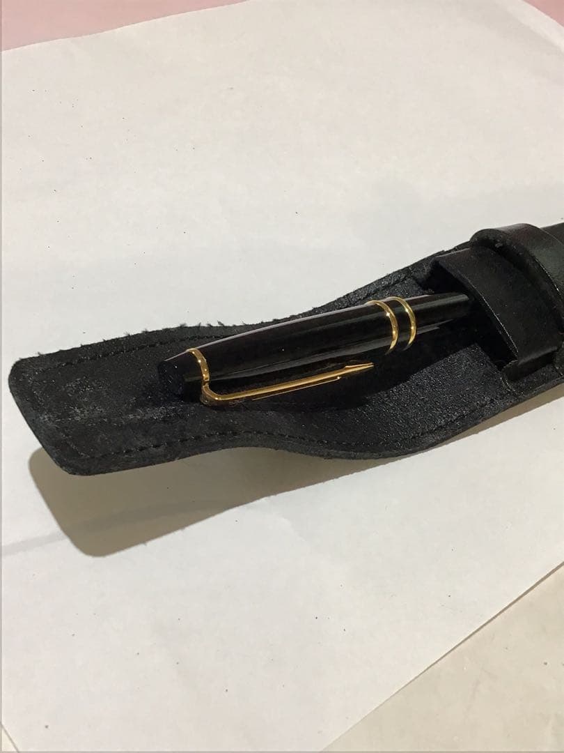 Waterman Paris black and gold ballpoint pen with leather case on white background
