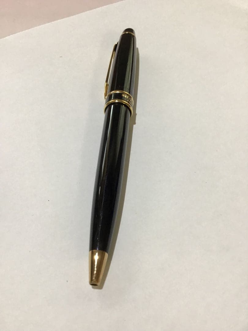 Waterman Paris black and gold ballpoint pen with leather case on white background