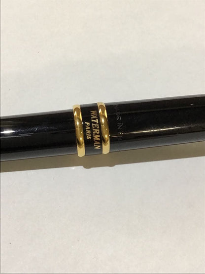 Waterman Paris black and gold ballpoint pen with leather case on white background