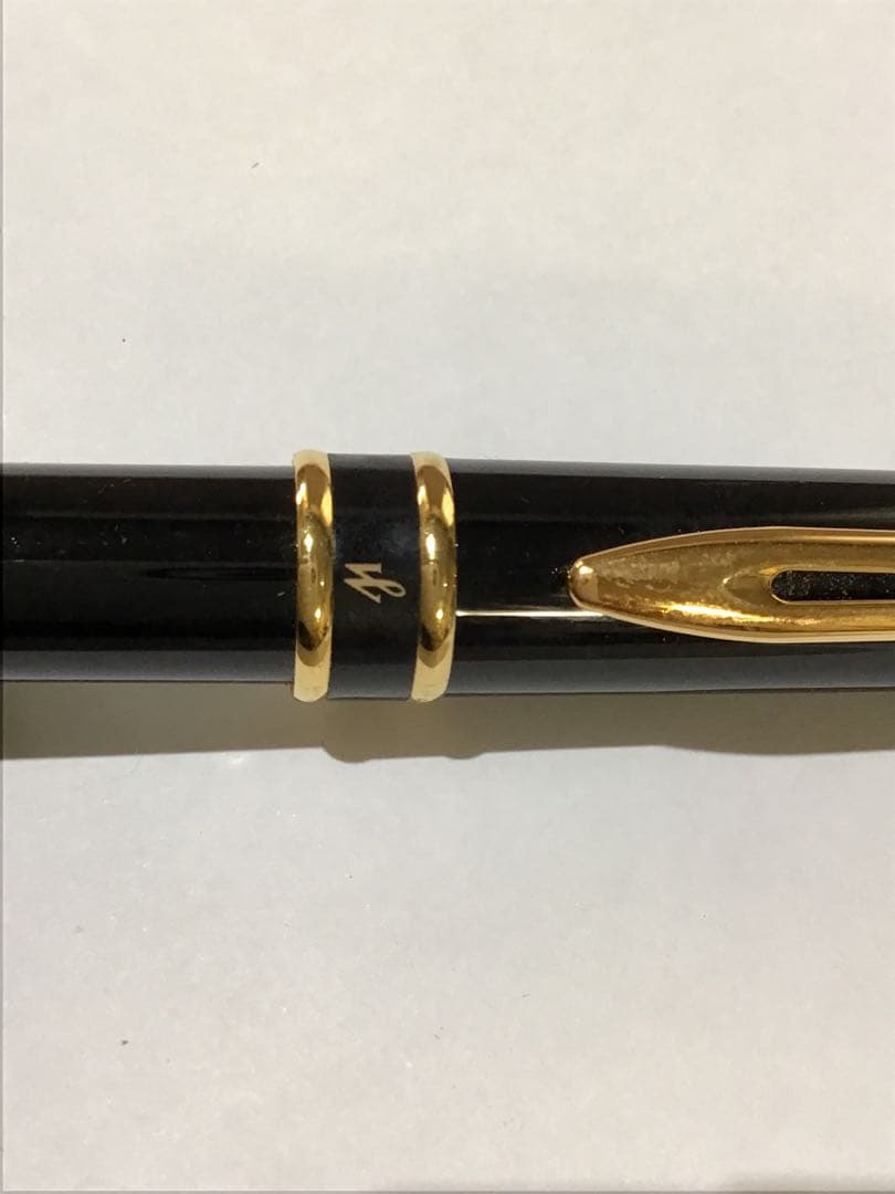 Waterman Paris black and gold ballpoint pen with leather case on white background