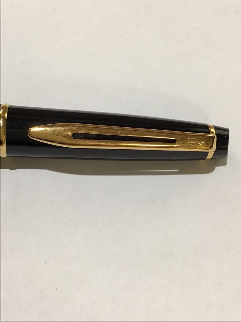 Waterman Paris black and gold ballpoint pen with leather case on white background