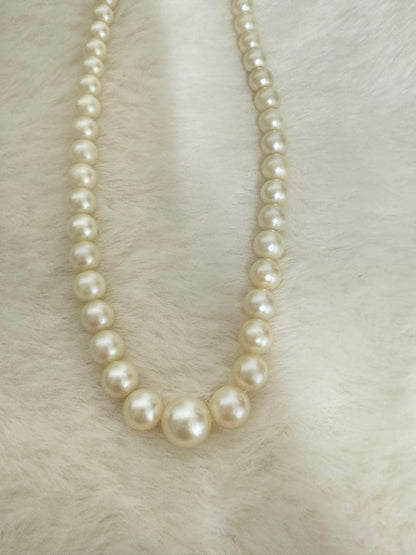 Mikimoto pearl necklace with white gold 14WG chain displayed alongside dedicated storage case