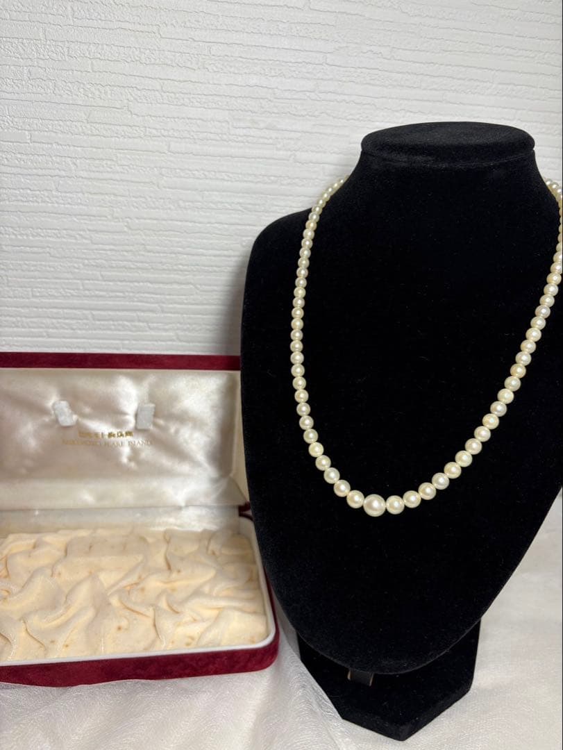 Mikimoto pearl necklace with white gold 14WG chain displayed alongside dedicated storage case