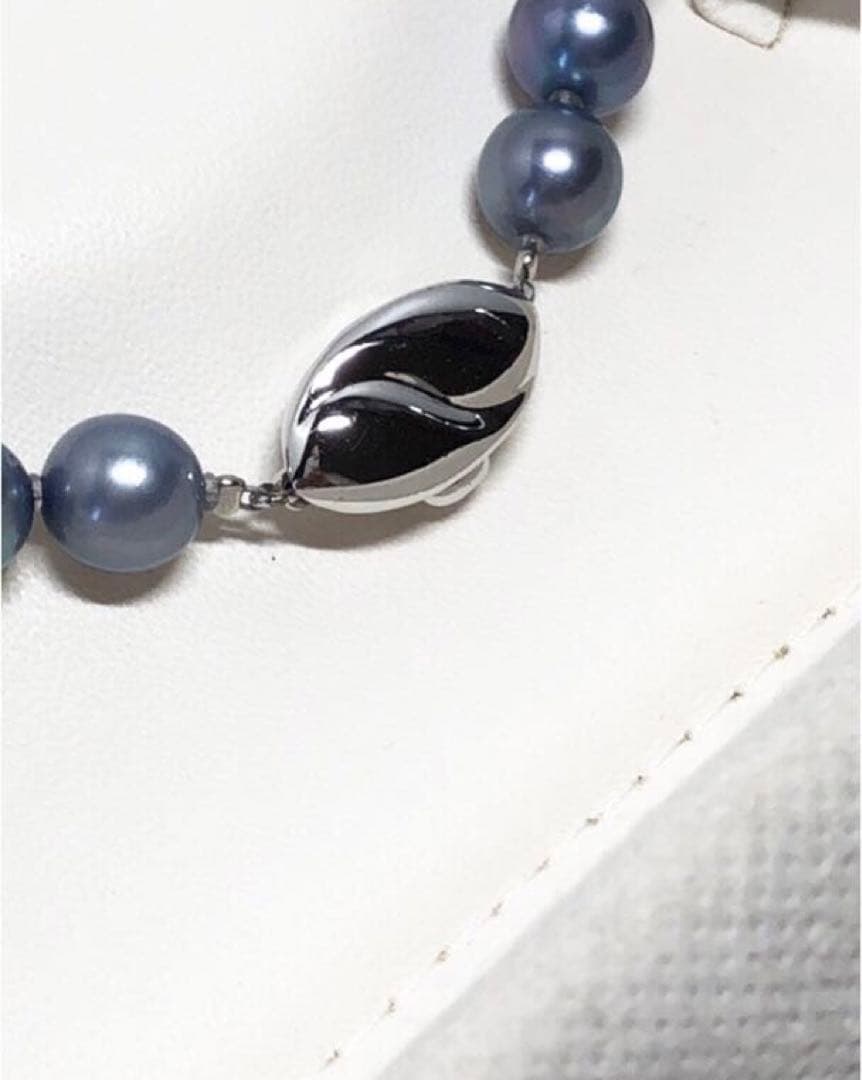 Akoya pearl necklace featuring 8mm semi-round gray pearls with blue and purple hues and silver one-push clasp
