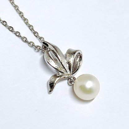Mikimoto pearl necklace with 6.7mm pearls featuring ribbon, flower, and leaf silver design on 40cm chain