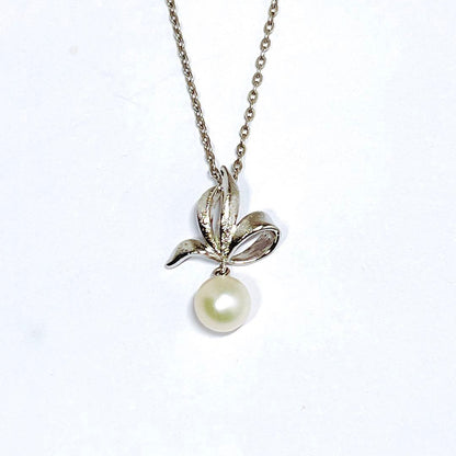 Mikimoto pearl necklace with 6.7mm pearls featuring ribbon, flower, and leaf silver design on 40cm chain