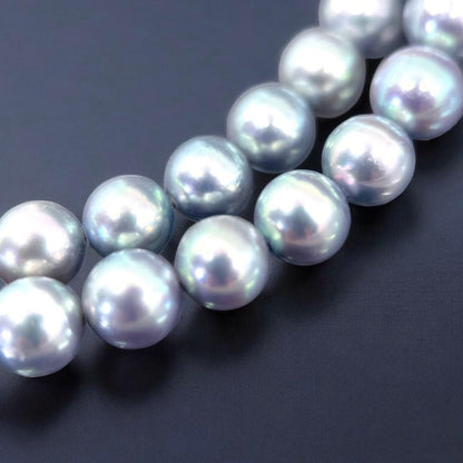 Tasaki Akoya pearl necklace and earrings set with 7mm round pearls and silver clasp on white background