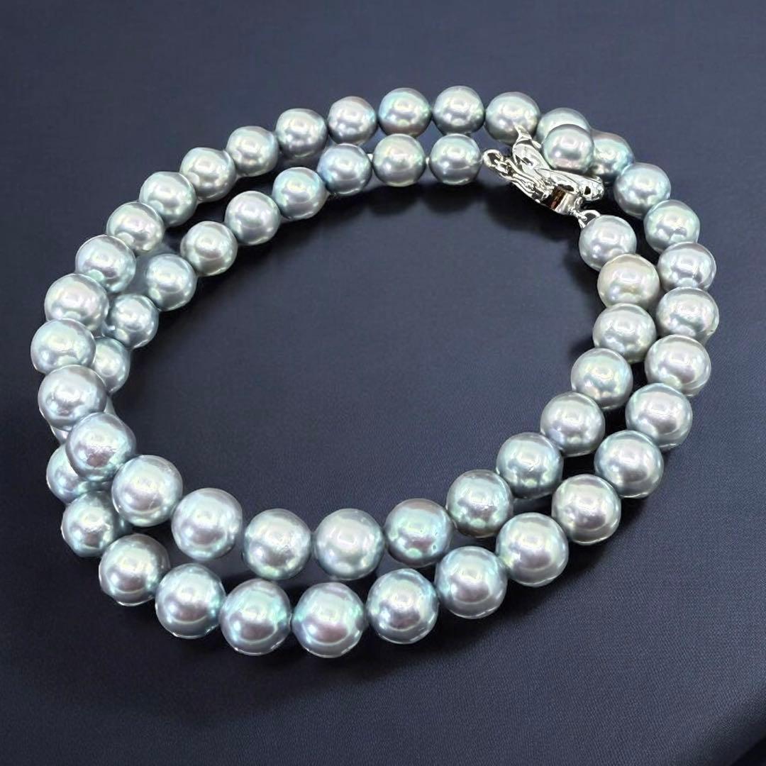 Tasaki Akoya pearl necklace and earrings set with 7mm round pearls and silver clasp on white background