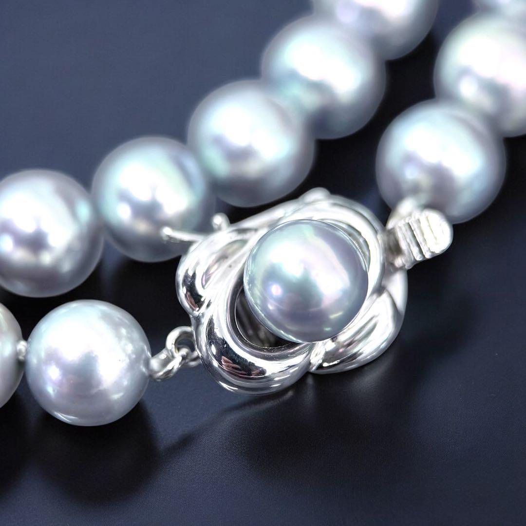 Tasaki Akoya pearl necklace and earrings set with 7mm round pearls and silver clasp on white background