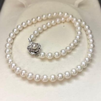 Akoya pearl necklace with 7mm round white pearls and silver markings, 43cm length, strong luster