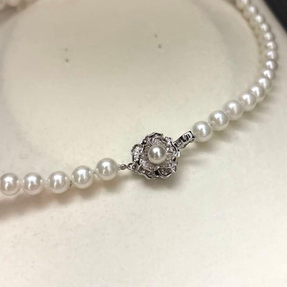 Akoya pearl necklace with 7mm round white pearls and silver markings, 43cm length, strong luster