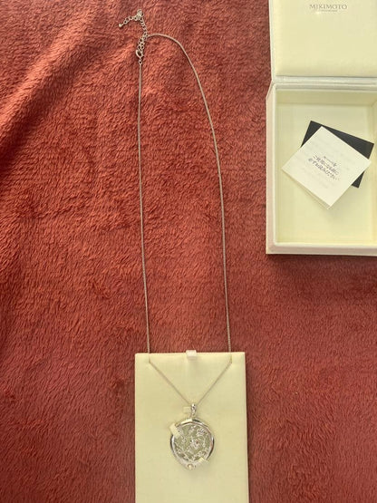 Mikimoto Loupe Pearl Necklace displayed with pearls and elegant design on a white background