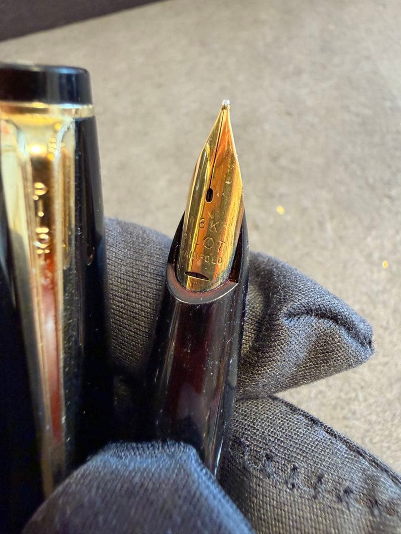 Elite black fountain pen with gold trim and gold finish clip made of metal, elegant design