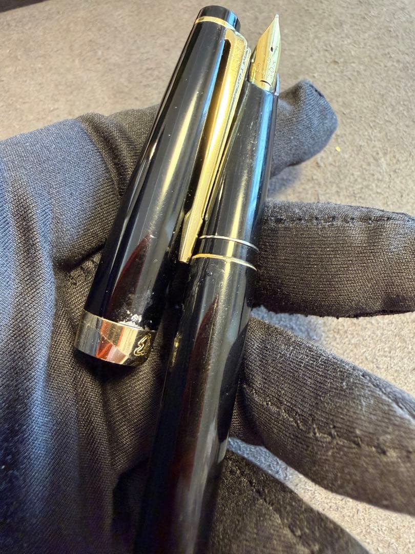 Elite black fountain pen with gold trim and gold finish clip made of metal, elegant design