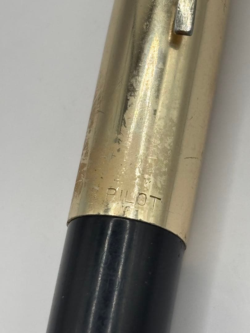 PILOT black fountain pen with 14k engraving and shiny gold cap shown on white background