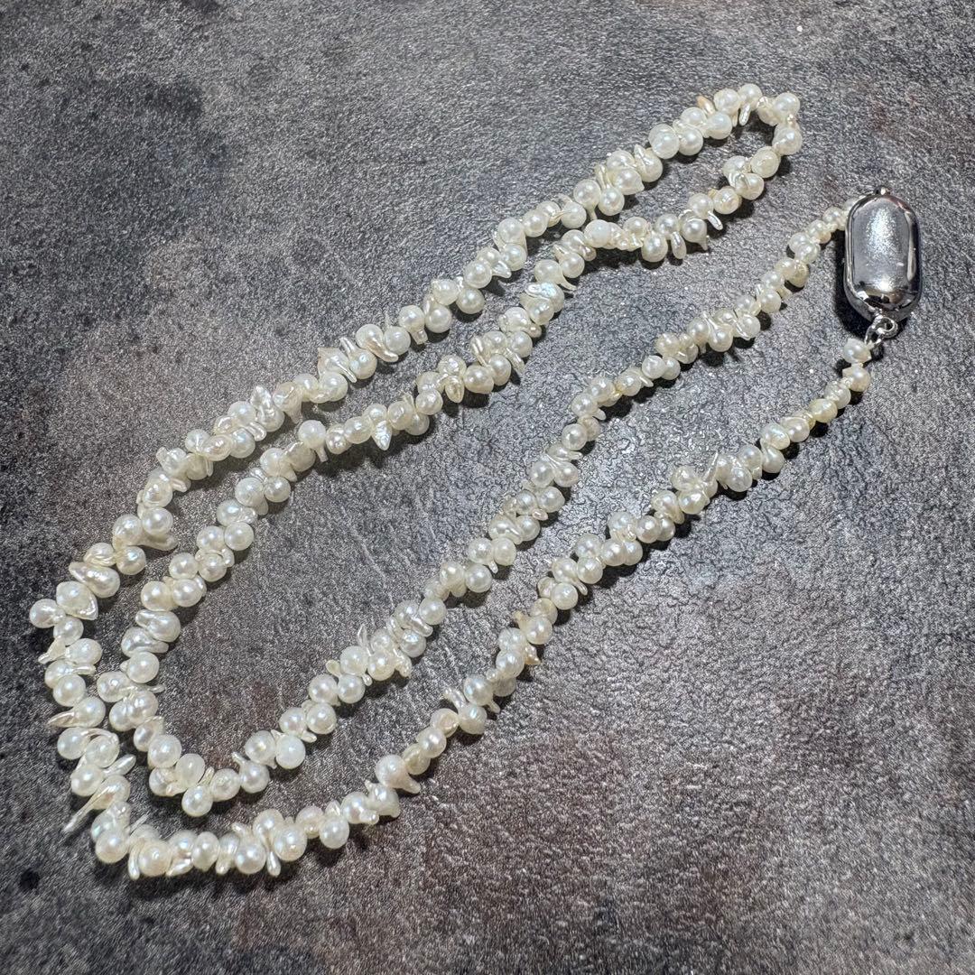 Akoya pearl necklace with silver clasp displayed on white background, 42 cm length
