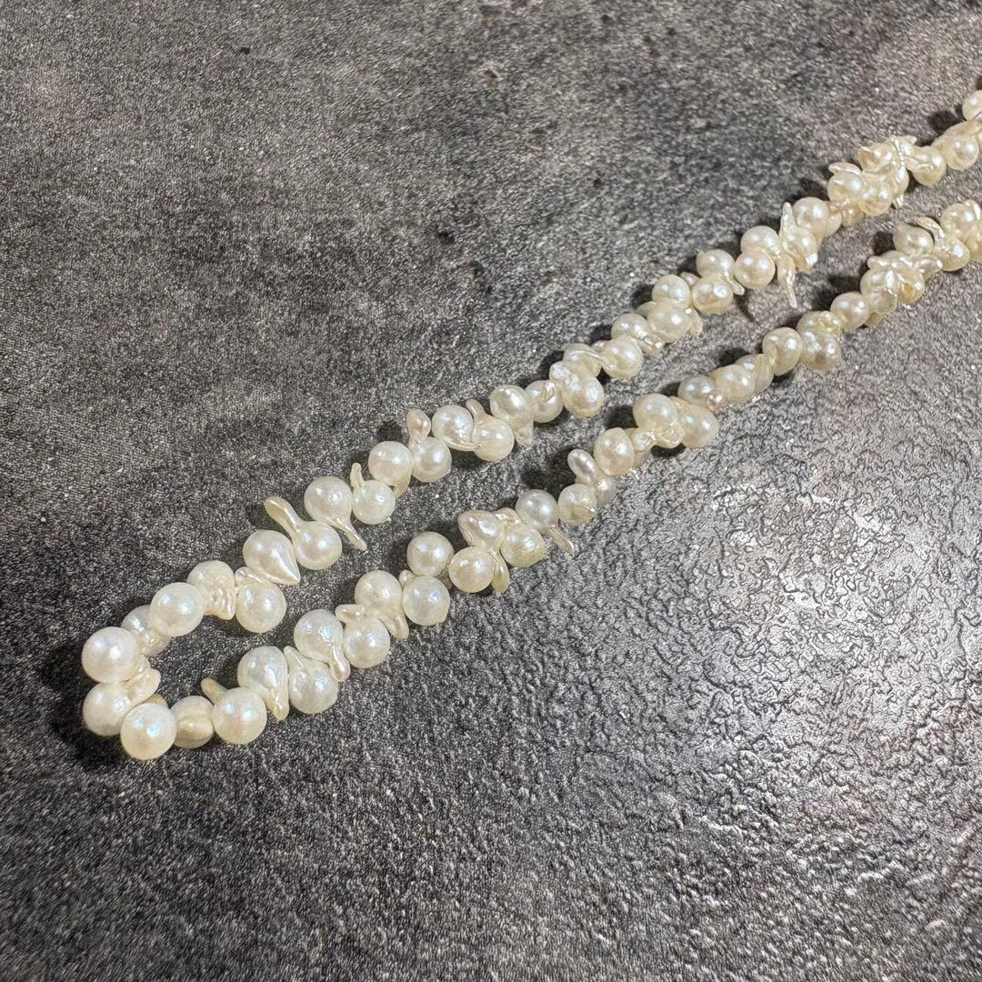 Akoya pearl necklace with silver clasp displayed on white background, 42 cm length