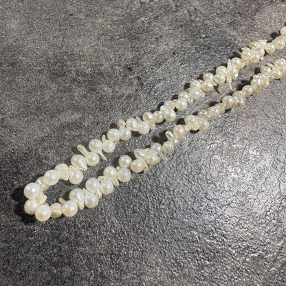 Akoya pearl necklace with silver clasp displayed on white background, 42 cm length