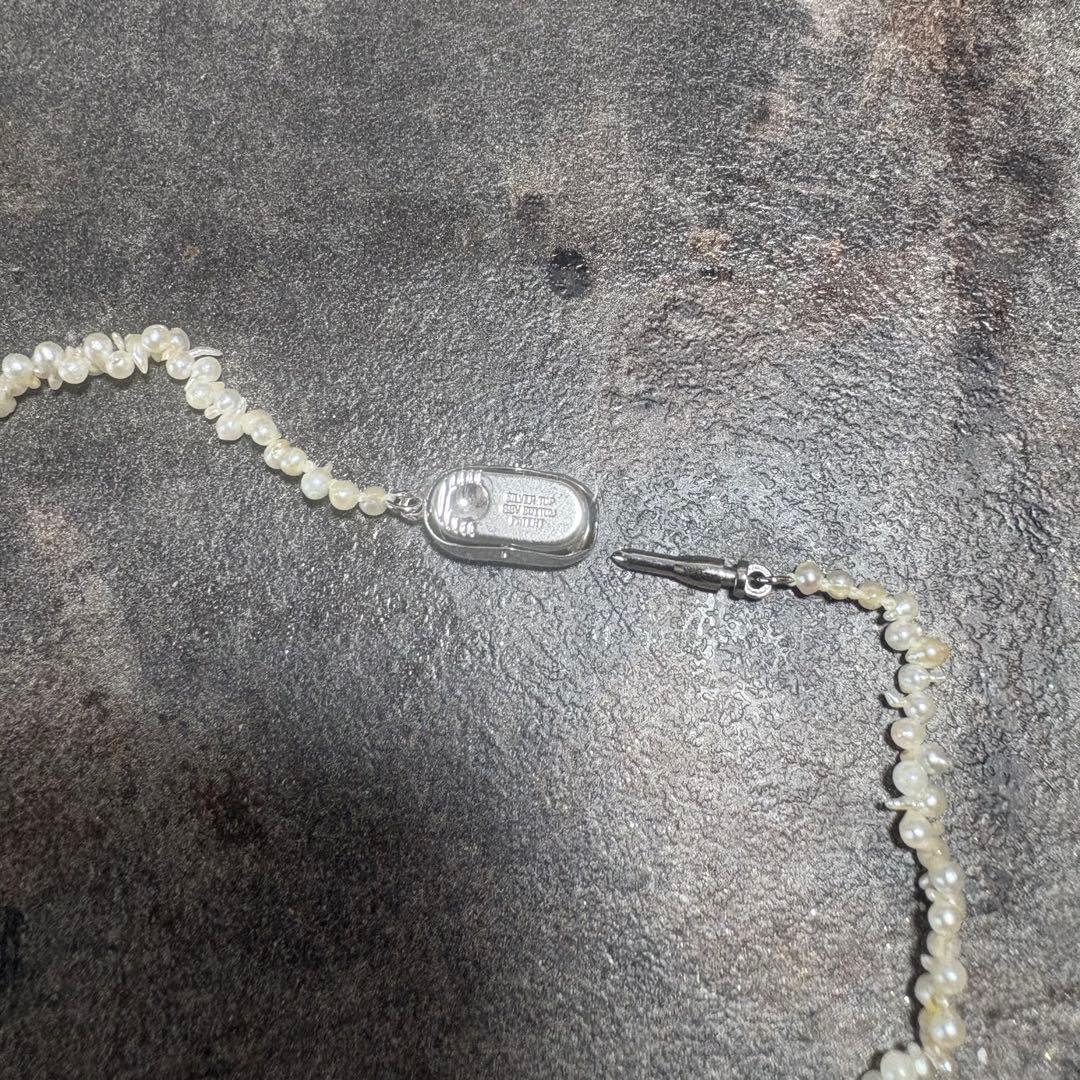 Akoya pearl necklace with silver clasp displayed on white background, 42 cm length