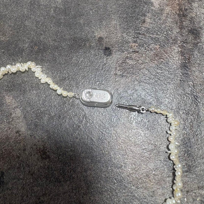 Akoya pearl necklace with silver clasp displayed on white background, 42 cm length