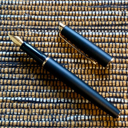 Waterman Hemisphere Matte Black GT fountain pen with gold nib and dedicated case on white background