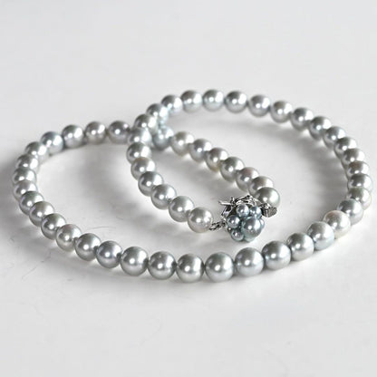 Tasaki Natural Blue Akoya Pearl Necklace 41 cm length with round pearls and silver clasp on white background