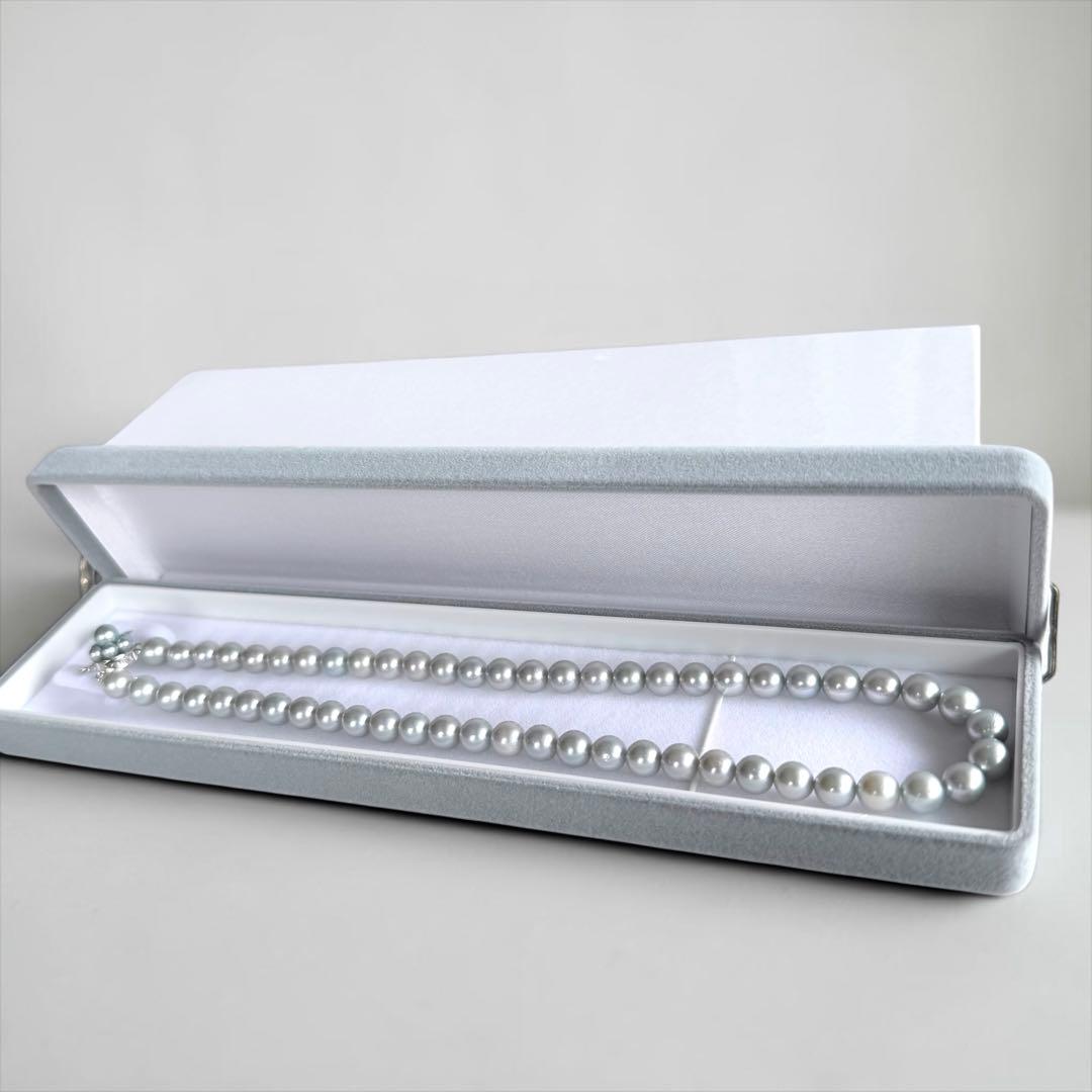 Tasaki Natural Blue Akoya Pearl Necklace 41 cm length with round pearls and silver clasp on white background