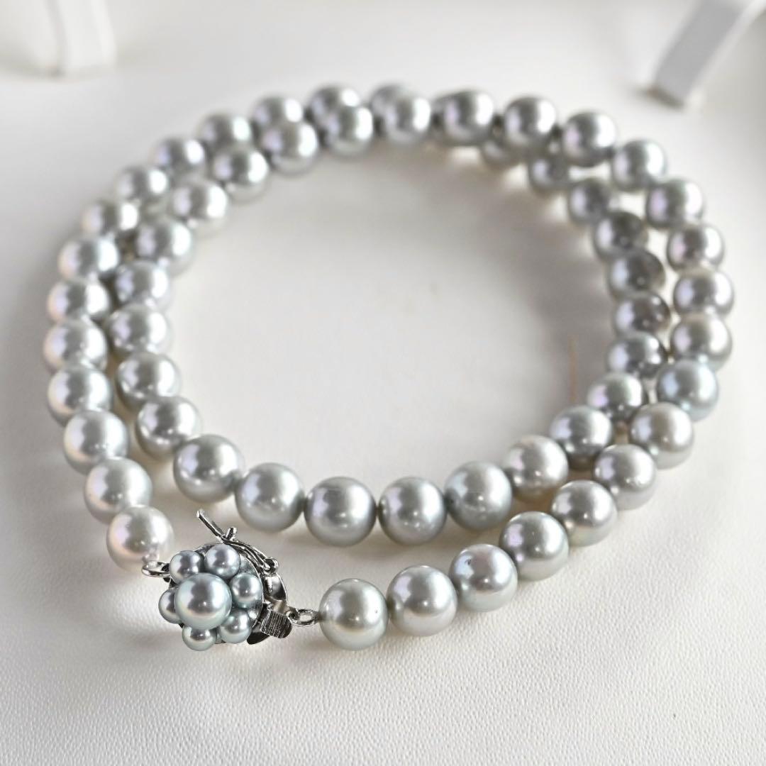 Tasaki Natural Blue Akoya Pearl Necklace 41 cm length with round pearls and silver clasp on white background