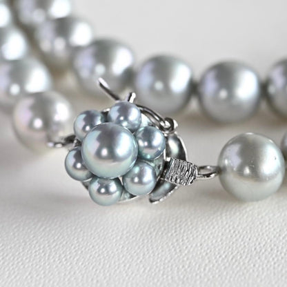 Tasaki Natural Blue Akoya Pearl Necklace 41 cm length with round pearls and silver clasp on white background