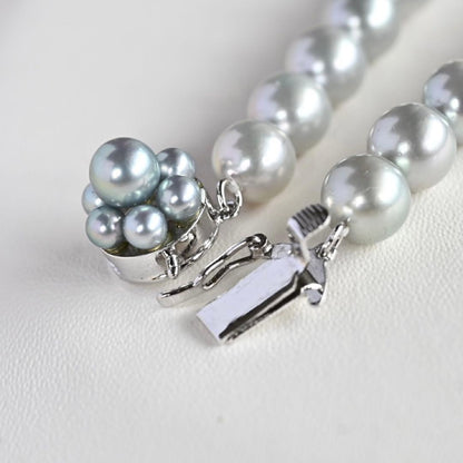 Tasaki Natural Blue Akoya Pearl Necklace 41 cm length with round pearls and silver clasp on white background