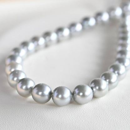 Tasaki Natural Blue Akoya Pearl Necklace 41 cm length with round pearls and silver clasp on white background