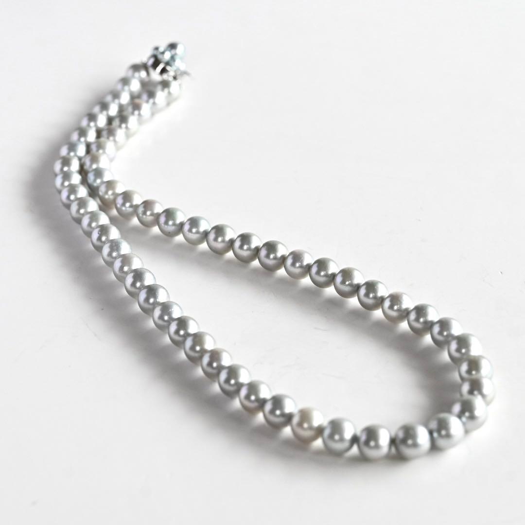 Tasaki Natural Blue Akoya Pearl Necklace 41 cm length with round pearls and silver clasp on white background