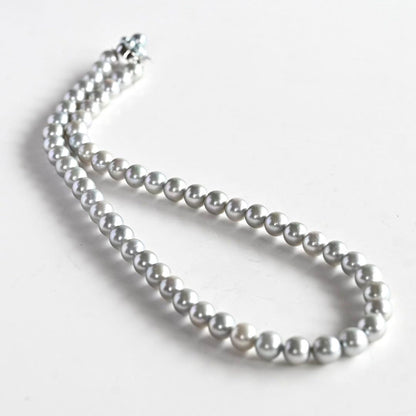 Tasaki Natural Blue Akoya Pearl Necklace 41 cm length with round pearls and silver clasp on white background