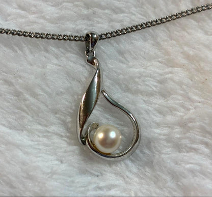 Mikimoto silver pendant necklace with a single pearl, displayed with dedicated jewelry case