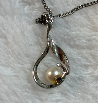 Mikimoto silver pendant necklace with a single pearl, displayed with dedicated jewelry case