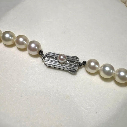 Mikimoto Akoya pearl necklace measuring 56cm with white and cream tone pearls sized 6.4 to 6.9mm
