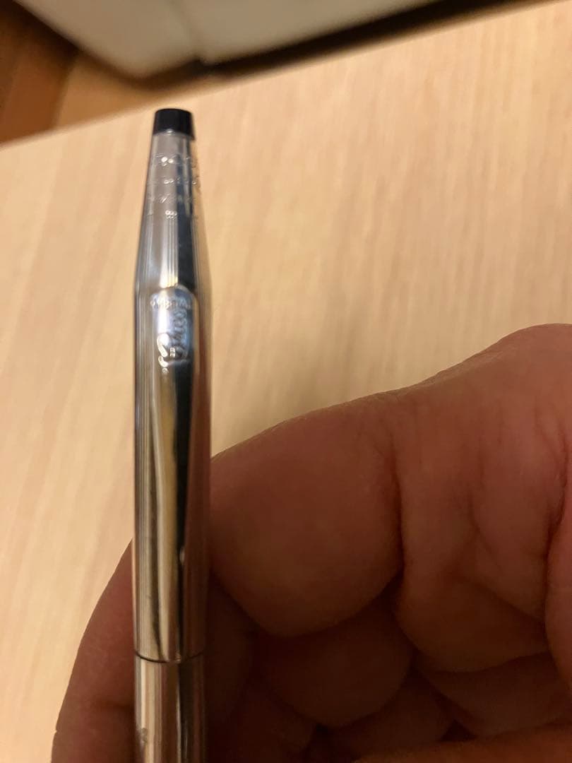 Kuro 925 silver ballpoint pen with slim body, black tip, and metal clip on a white background