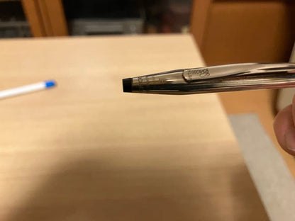 Kuro 925 silver ballpoint pen with slim body, black tip, and metal clip on a white background