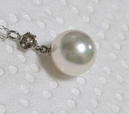Akoya pearl and diamond pendant necklace featuring 8.3mm round white-green pearl with platinum chain