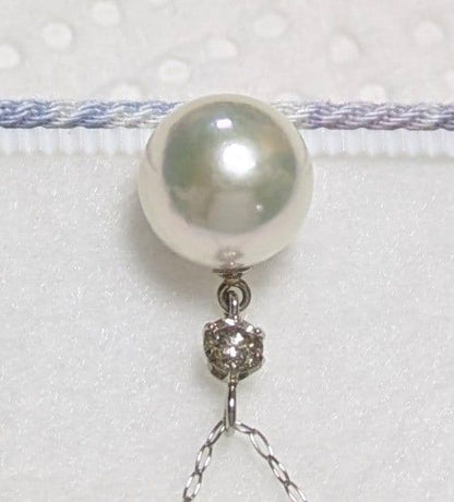 Akoya pearl and diamond pendant necklace featuring 8.3mm round white-green pearl with platinum chain