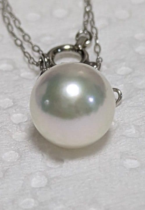 Akoya pearl and diamond pendant necklace featuring 8.3mm round white-green pearl with platinum chain