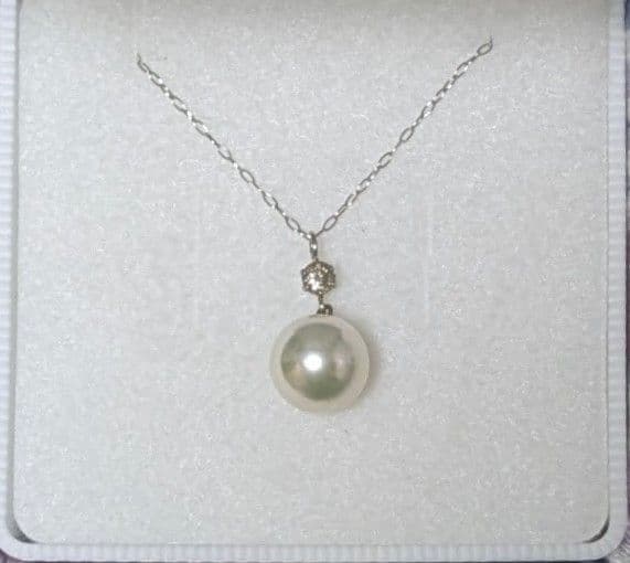 Akoya pearl and diamond pendant necklace featuring 8.3mm round white-green pearl with platinum chain