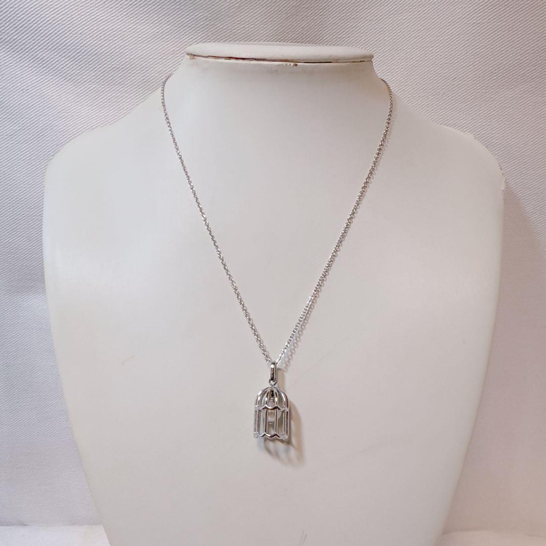 Tasaki Pearl Basket Necklace with bell sound made of 925 silver, shown on white background